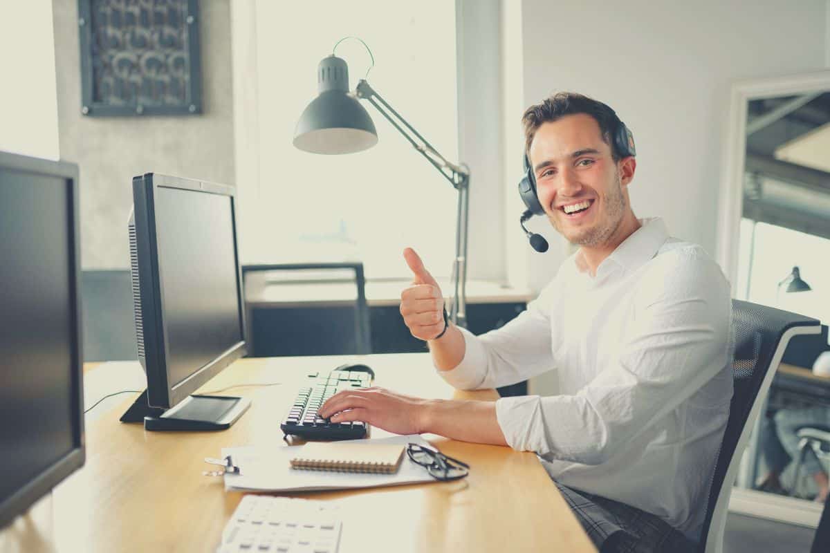 Thumbs up from office worker wearing a headset