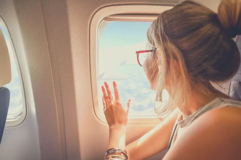 Woman looking out the window of a plane