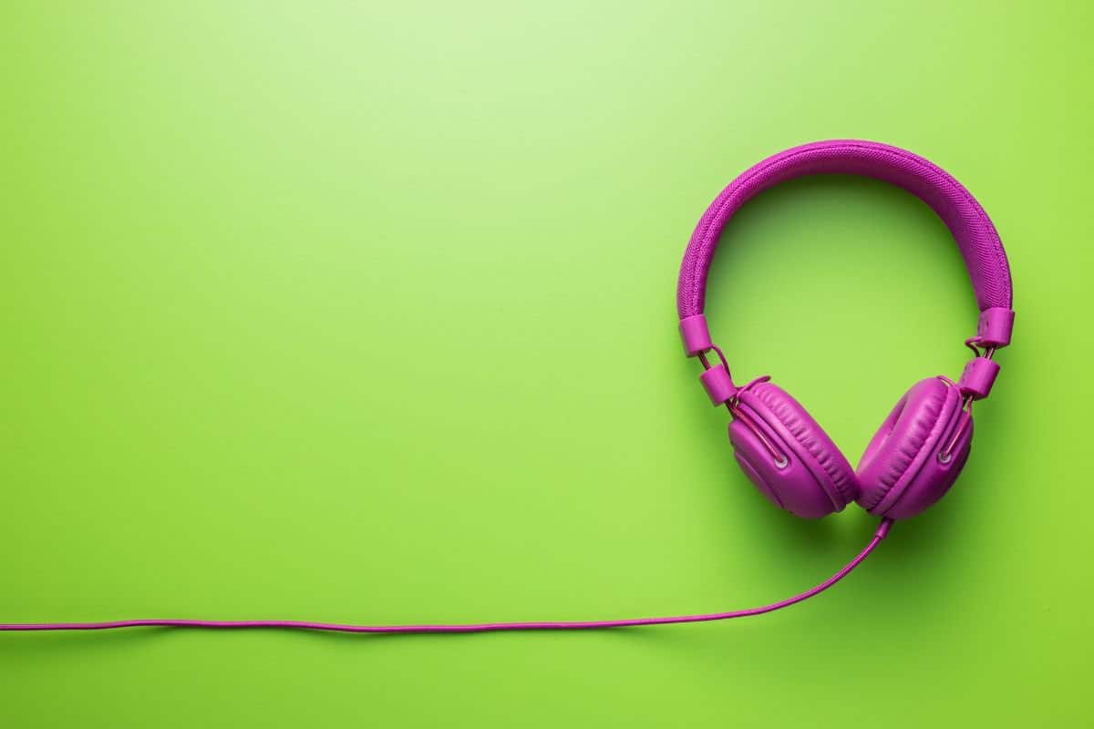 Pink headphones on a green background