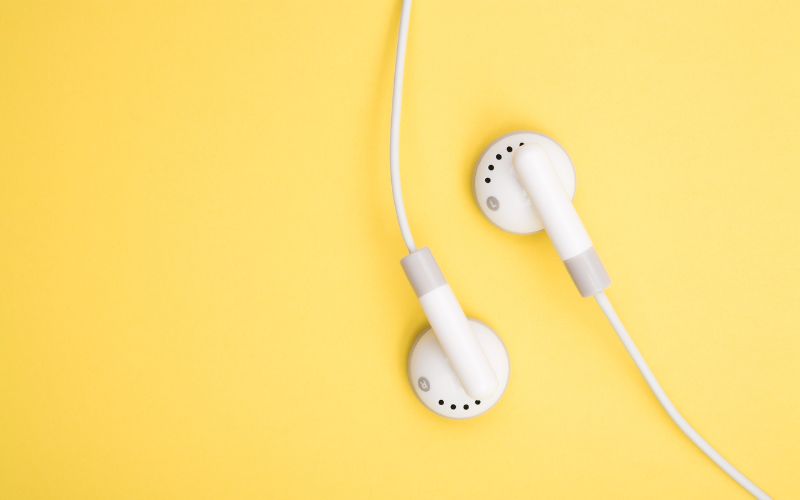 Wired earbuds on yellow background